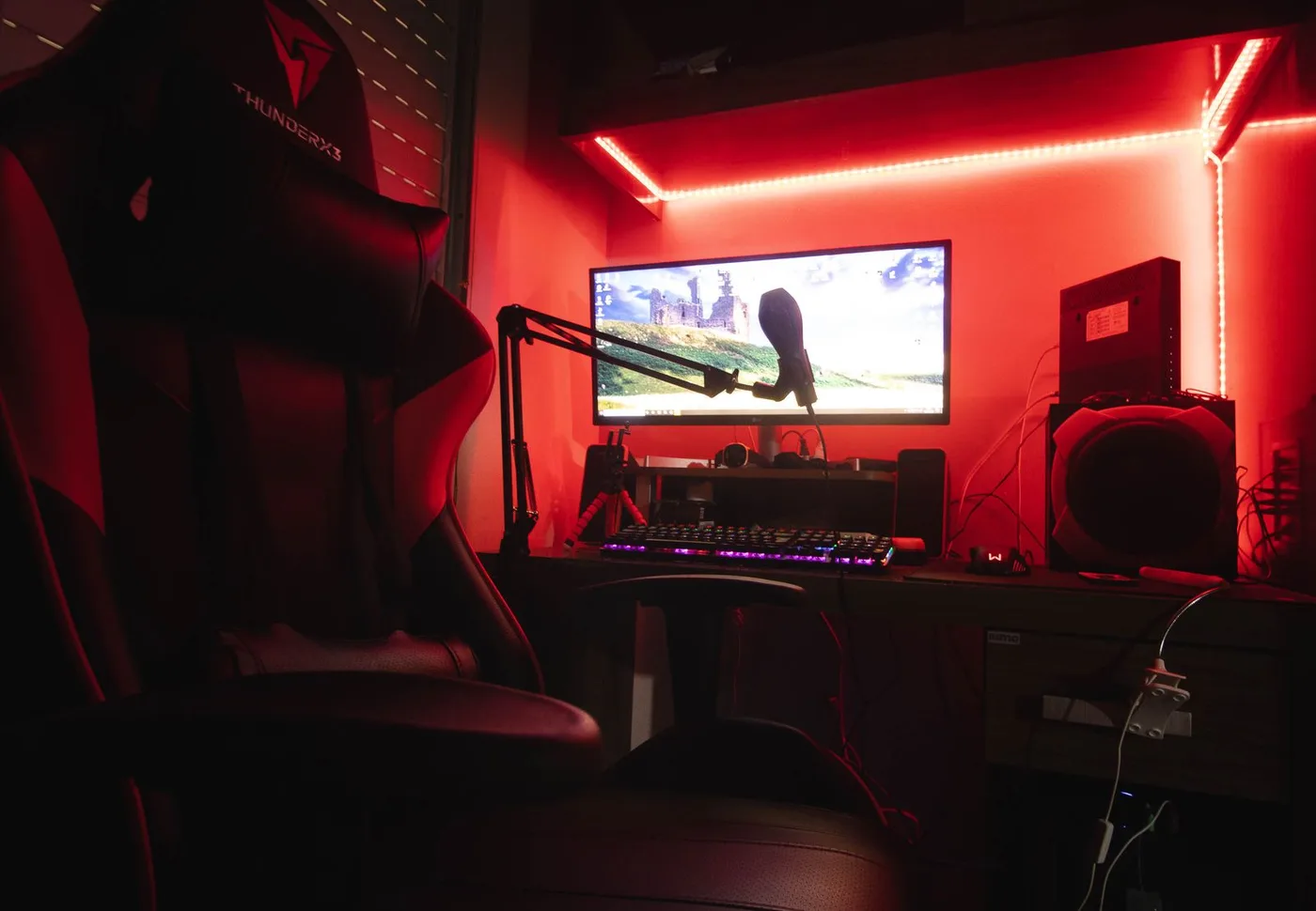 Microphone and computer in a creator’s recording workspace